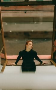 Woman taking a quiet moment at an open window