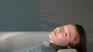 A person resting on a sofa in soft daylight