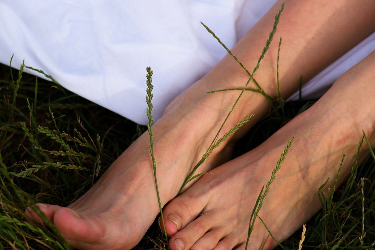 Bare feet resting on grass during a quiet outdoor pause